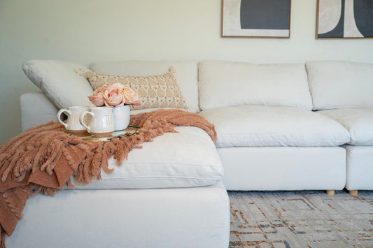 Lunn Cloud Sectional close-up with throw and mugs